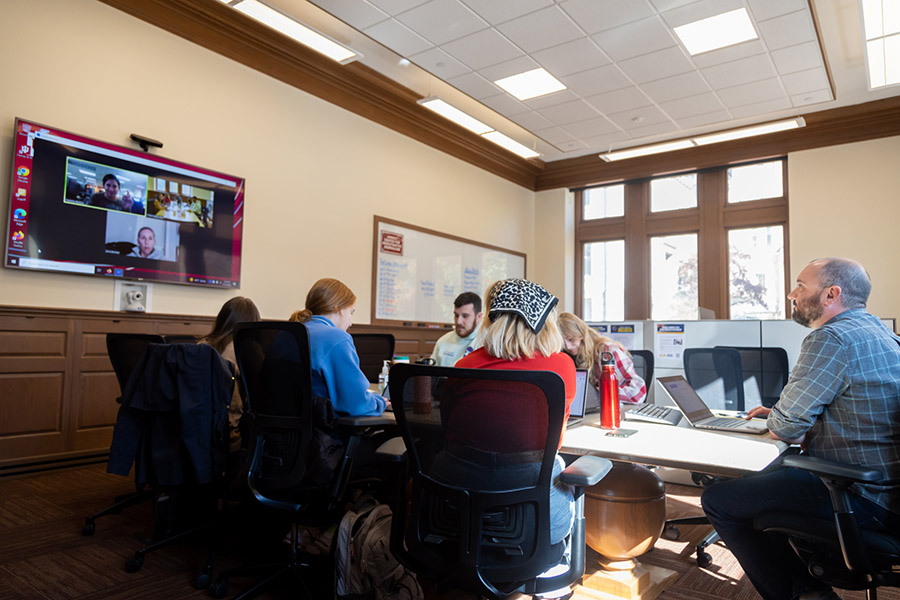 A group of students working in a conference room.